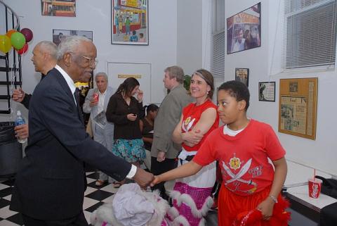 Gala awardee Dr. Franklin and Yanno the lion dancer greet each other.