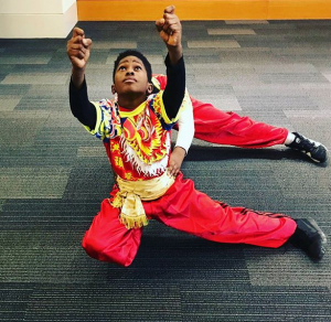 Young lion dances warm up before performance without lion costume.